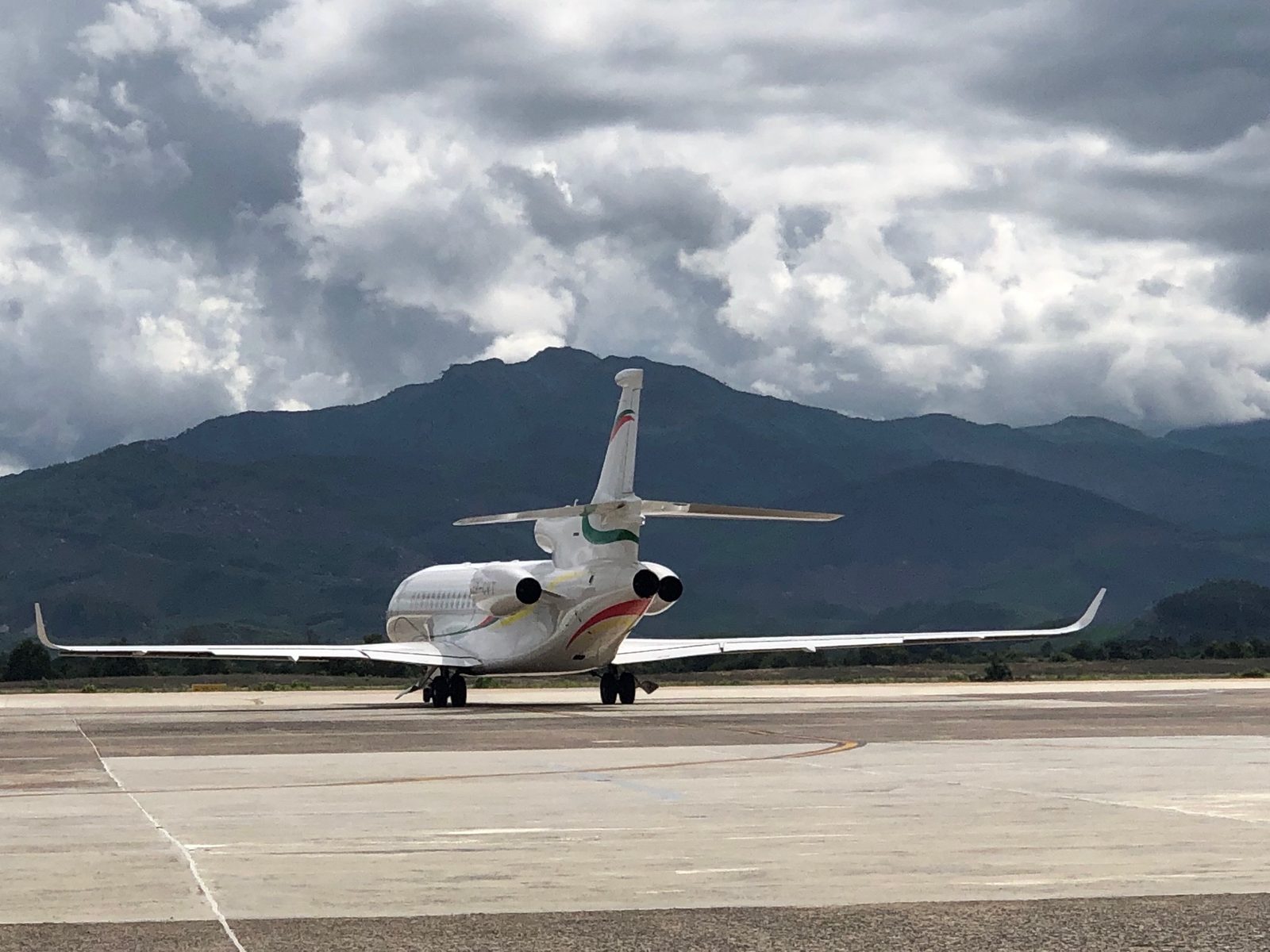 Business jet on the apron in front of mountains