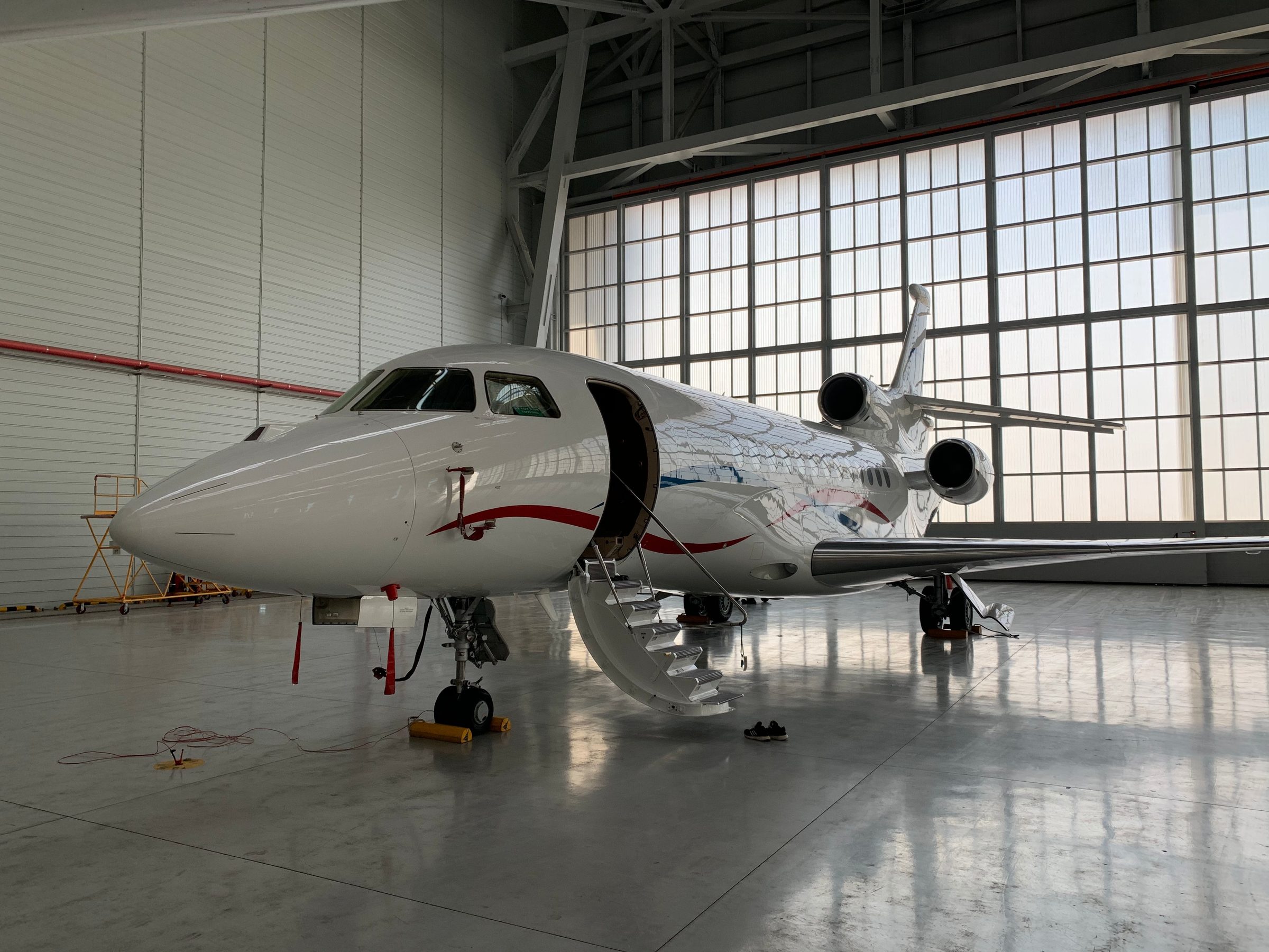 Falcon 8X in a bright maintenance hangar